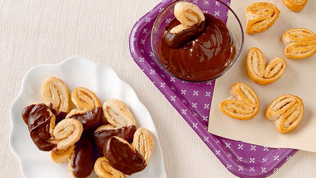 chocolate dipped palmiers on plate and chocolate dip