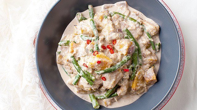 Ginataang gulat or vegetables in coconut milk on a blue-gray plate