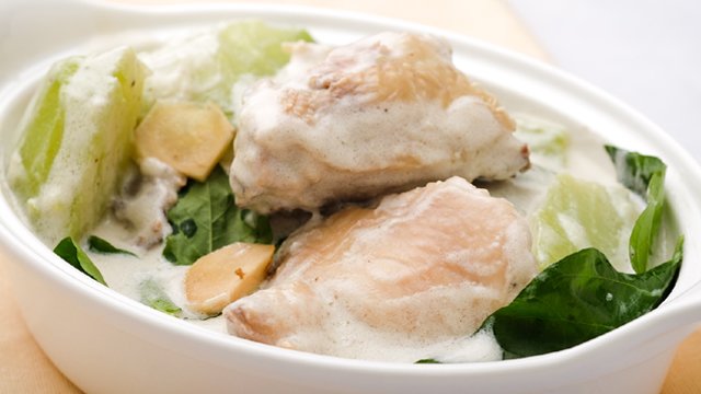 ginataang manok or chicken in coconut mik with sayote in a white bowl