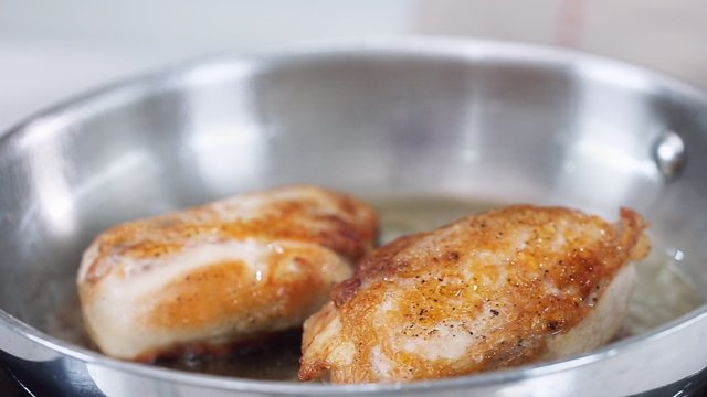 seared chicken breasts in a frying pan