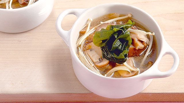 three mushroom miso soup in a bowl with handles