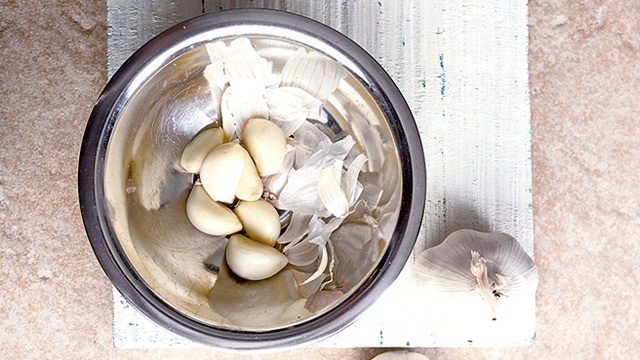 fresh garlic in a bowl some with and some without peels