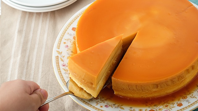 leche flan cheesecake with one slice being taken out
