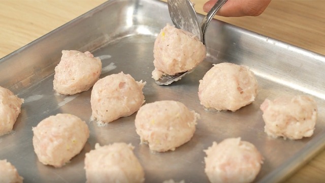 chicken ball mixture or paste portioned and formed into balls on a tray
