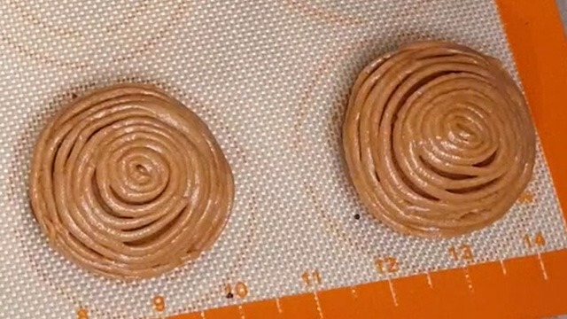 milo bread rolls topped with milo cookie topping on a silicone mat before before baking 