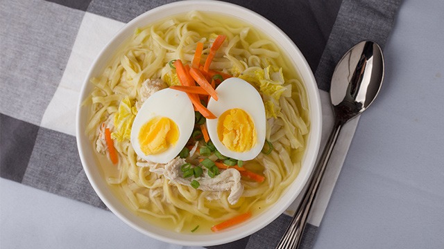 bowl of chicken mami with hard boiled eggs, carrots, green onions recipe image